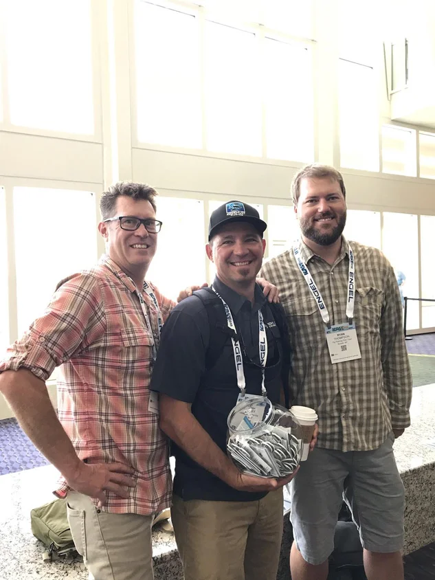 Old friends. Chris Keig and Ryan Thompson of The Fly Fishing Film Tour pose for grip and grin with Bryan Huskey and a Keepemwet fish bowl.