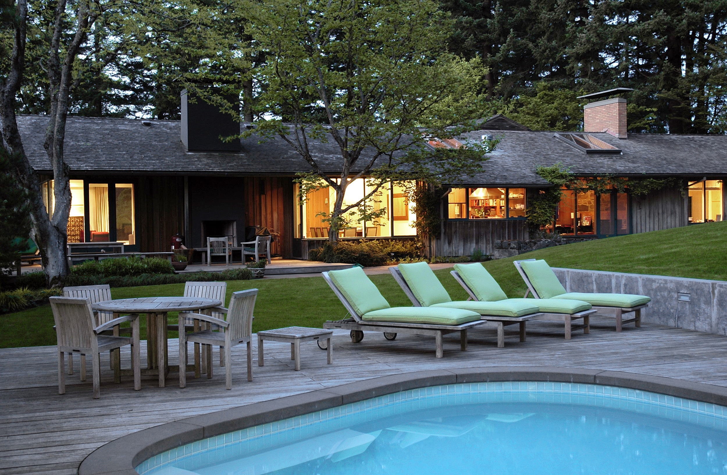 Location: Portland, Oregon Architect: John Storrs (original) Design: Green Gables Construction: Green Gables When a tall, gruff man appeared on her doorstep the owner immediately realized it was John Storrs, the revered Portland architect and original designer of the house. There had been extensive renovation and a substantial addition to the home. Storrs was curious to see what had been done. His approval testified to the client's respect for the existing architecture and love for things contemporary. A new wing has left most of the original structure and gardens undisturbed while repairing the weakest element of the existing architecture, the entry. Existing garage doors have been moved away from the front door and an entry courtyard now replaces what was once an asphalt driveway. Passing through a gateway the path to the front door now leads through a garden with an overlook onto a water feature. The walk into the house from the garage passes by large windows with views into the landscape and entry garden. The main garden on the south side of the house has been given new life. Simple horizontal architectural elements set off the existing kidney shaped pool and redefine the garden edges.