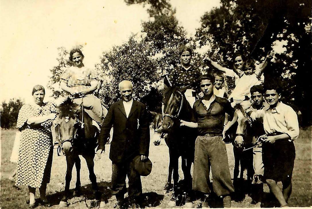 The Iliadis family in Verea, Greece in the 1930s. George Iliadis, Elizabeth's father, is the young boy in the background straddling two mules.