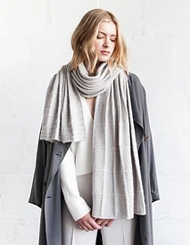 Worked in light and exquisite Sno, this shawl has a graduating grid pattern articulated in simple stockinette lines and seed stitch pattern. This juxtaposition of textures forms gentle pleats when worn loose and long. Downlown from Ravelry Here