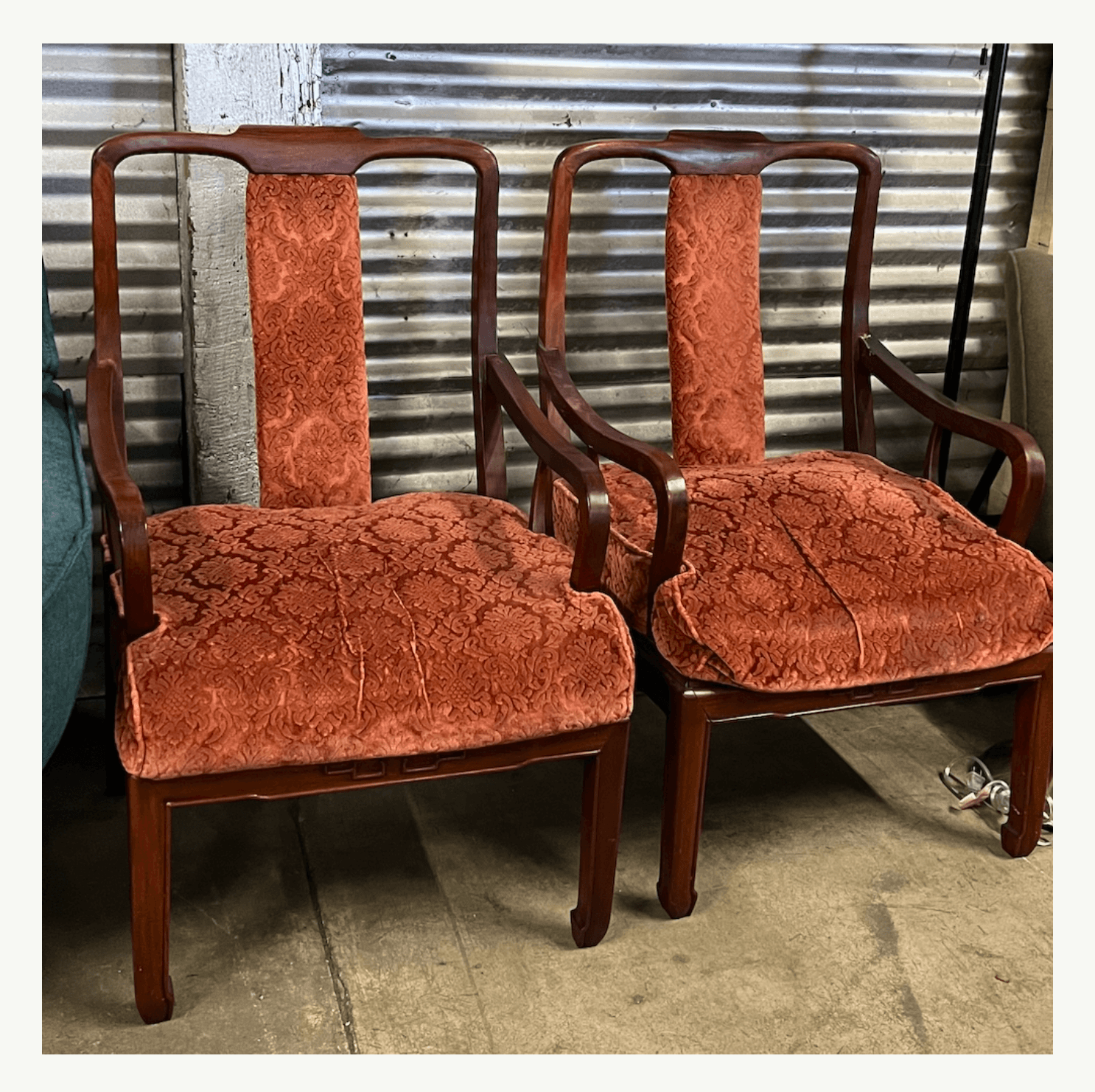 Pair of antique Chinoiserie armchairs with carved dark wood frames and worn rust-red damask upholstery at Poor Honey's Oakland — perfect for reupholstery