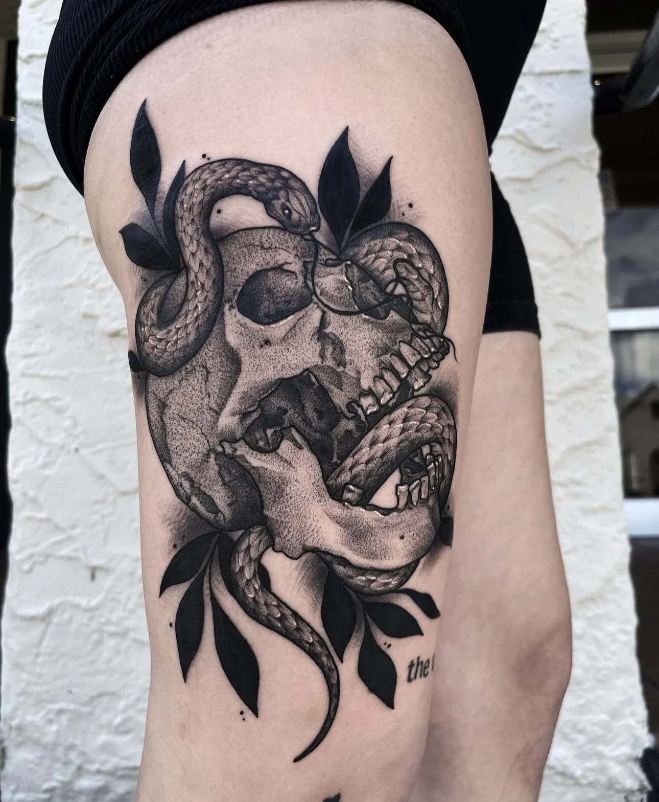 blackwork skull and serpent thigh tattoo by ayanah st louis