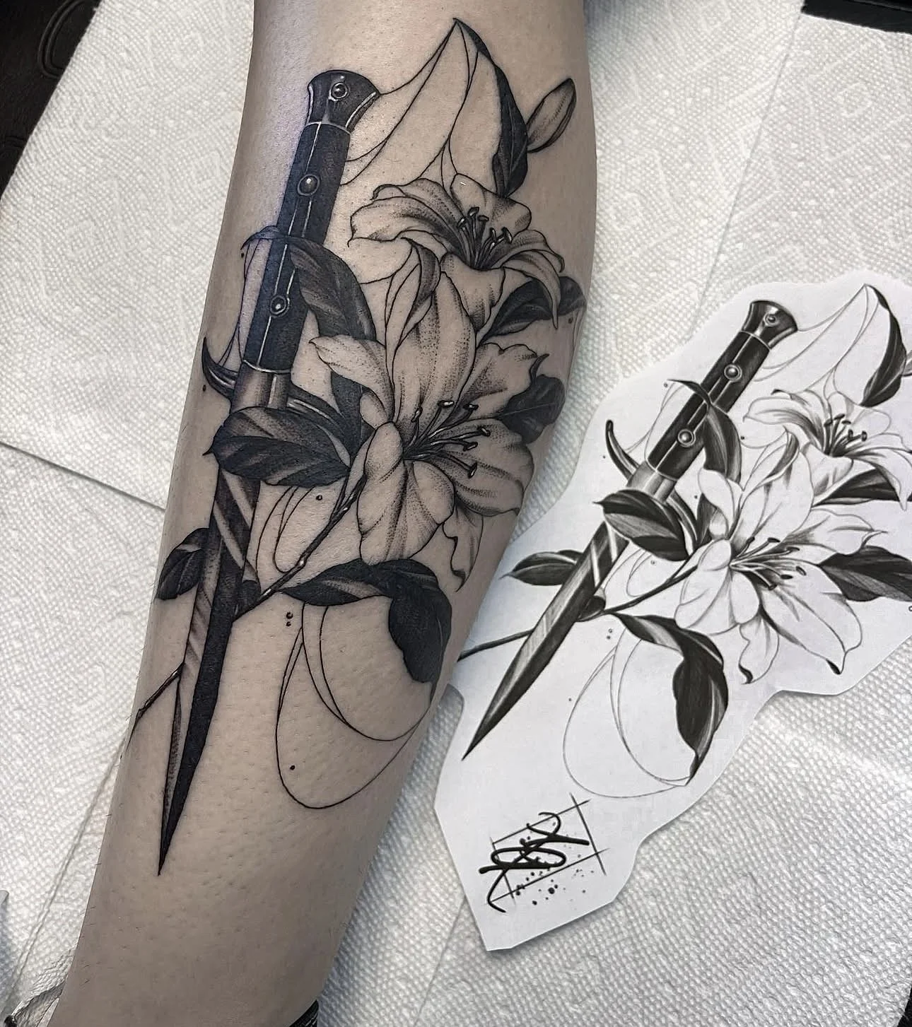 dagger and lily blackwork tattoo by ayanah st louis