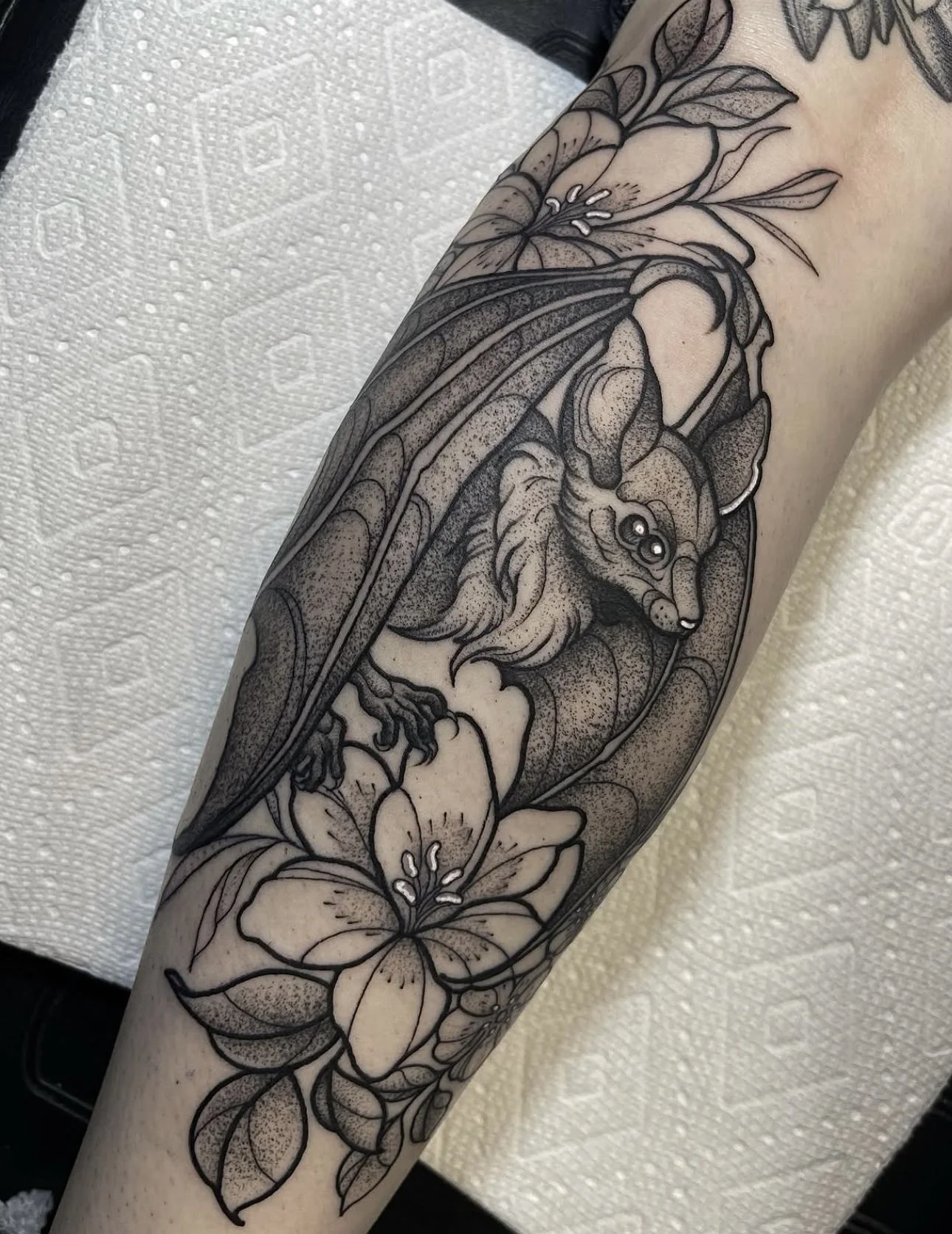 bat and floral blackwork tattoo by ayanah st louis