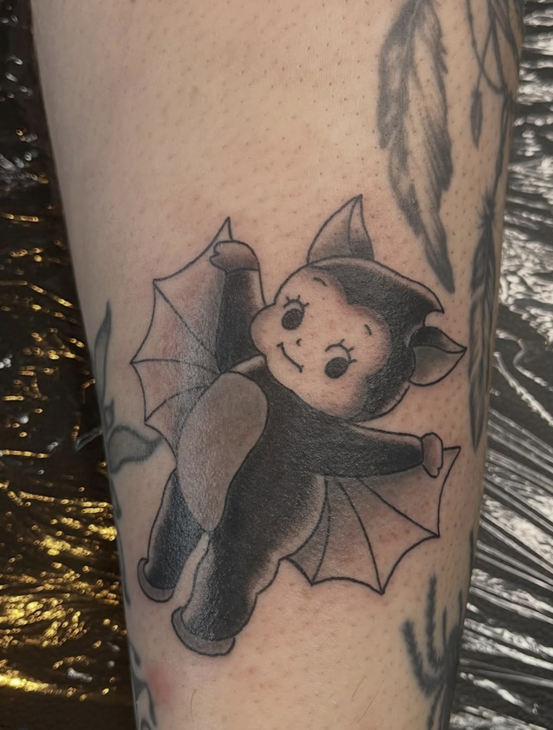 Black and Grey Cupie Bat Tattoo by lacey Sehie
