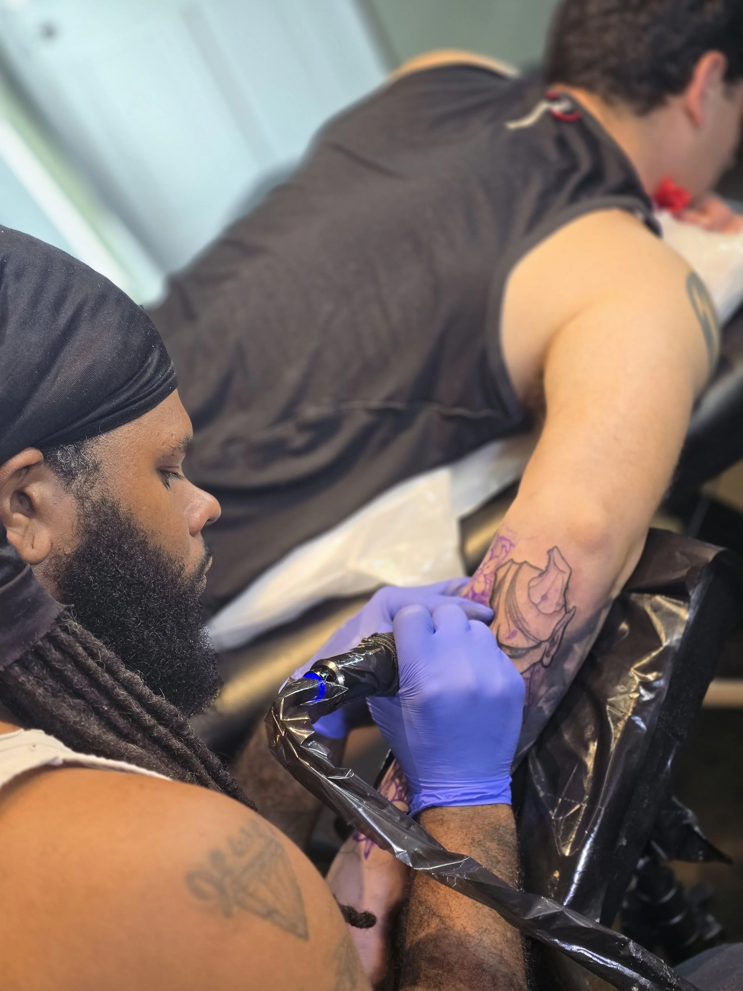 Outer lower arm tattoo in progress showing a placement that often feels more painful.