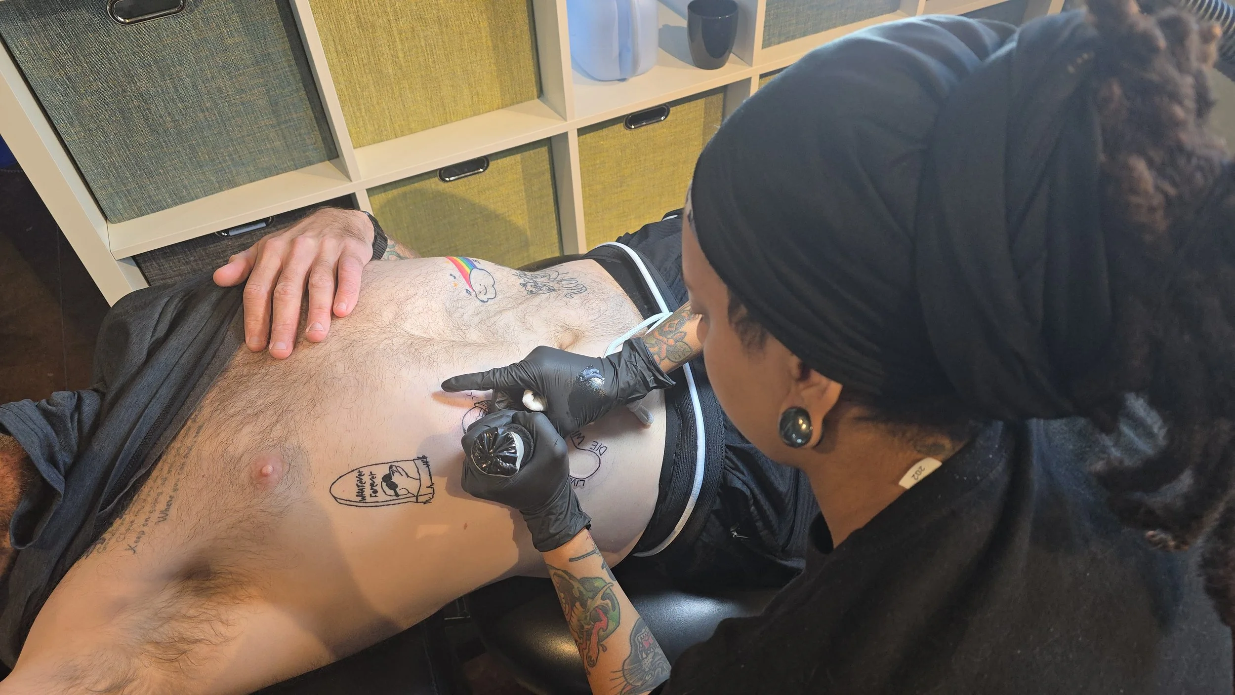 Rib tattoo in progress showing a placement that often feels more intense.