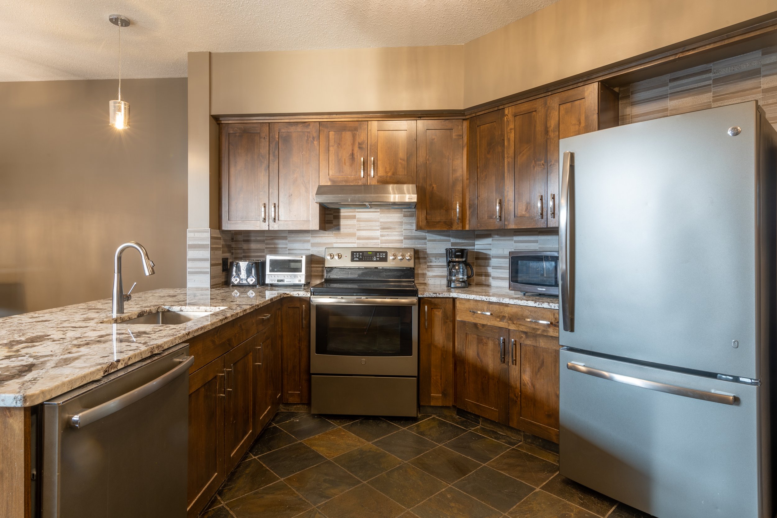 Fully Equipped Kitchen in Glacier Mountaineer Lodge | 3-Bedroom Suite