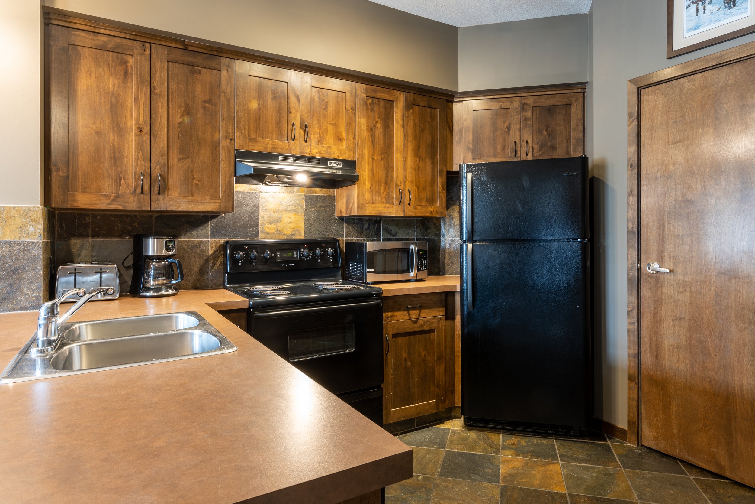 Fully Equipped Kitchen in Glacier Mountaineer Lodge | Two-Bedroom Suite
