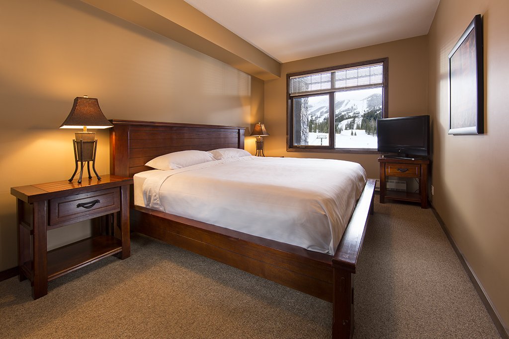 Comfortable Bedroom in Glacier Mountaineer Lodge | One-Bedroom Loft Suite