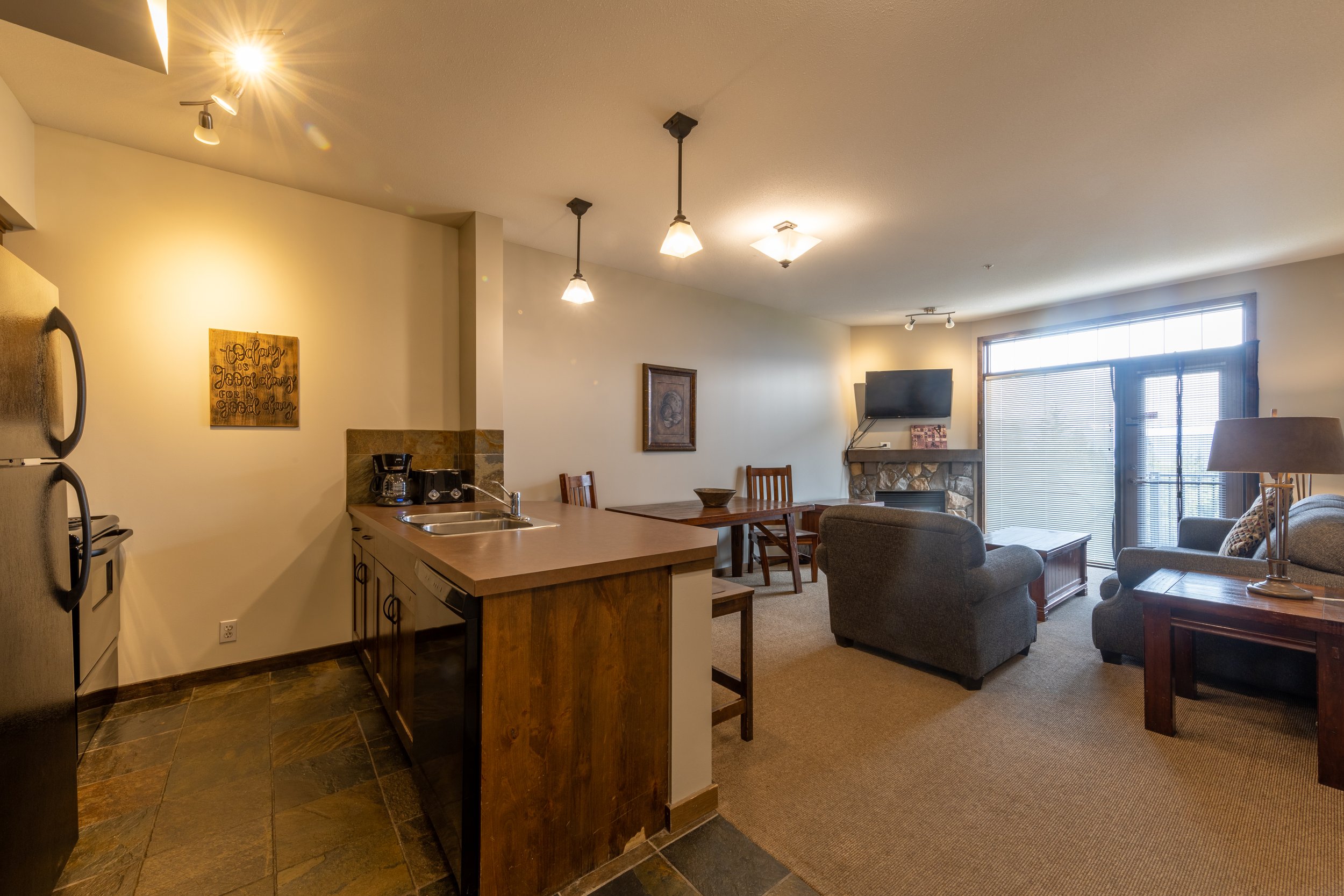 Convenient Kitchen and Cozy Living Room in Glacier Mountaineer Lodge | 1-Bedroom Suite