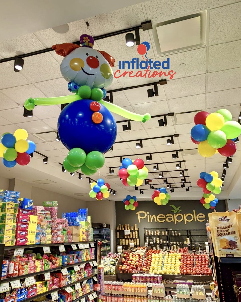 Corporate Grocery Supermarket Balloon Decorations clowns puffball topiaries chandeliers ceiling