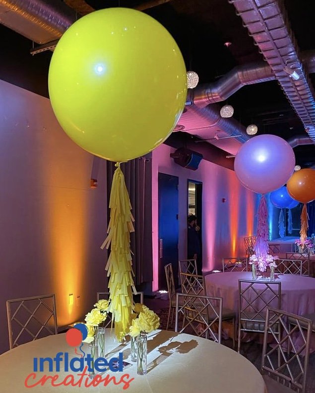 Neon graffiti party balloons with tassels and roses centerpieces. yellow, orange, pink, blue