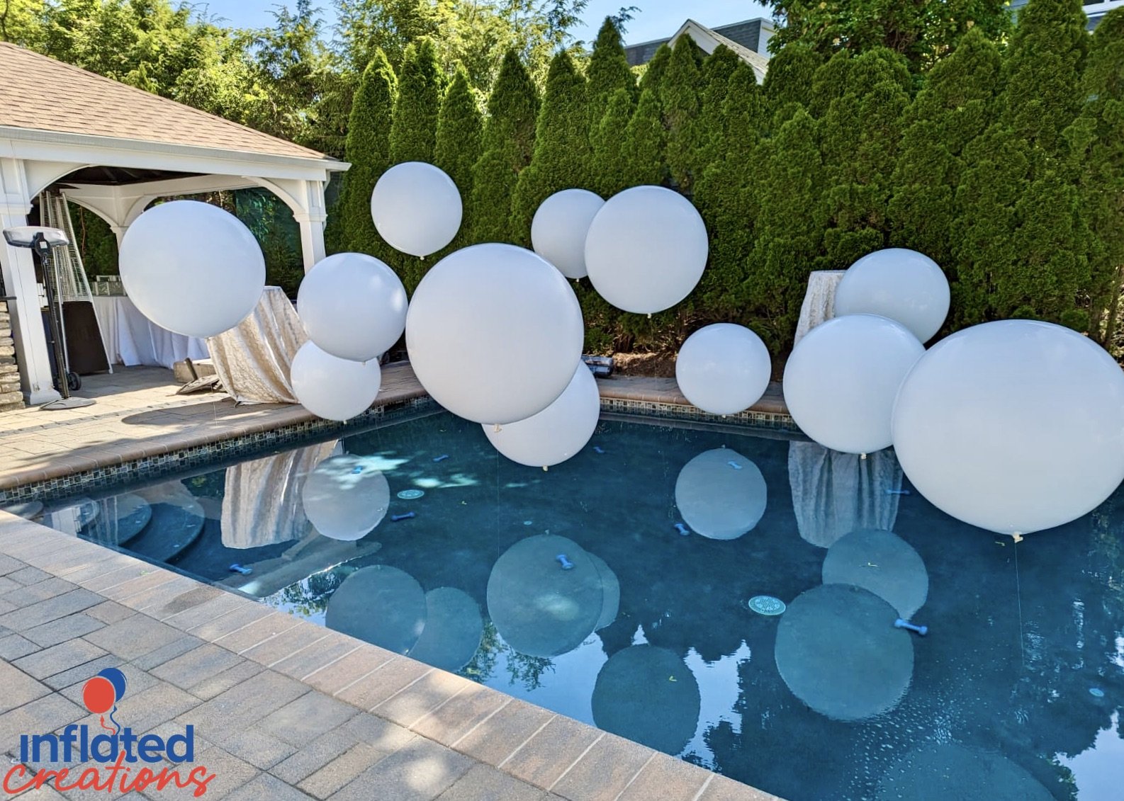 Engagement party outdoor pool balloon decor elegant white floating big impact