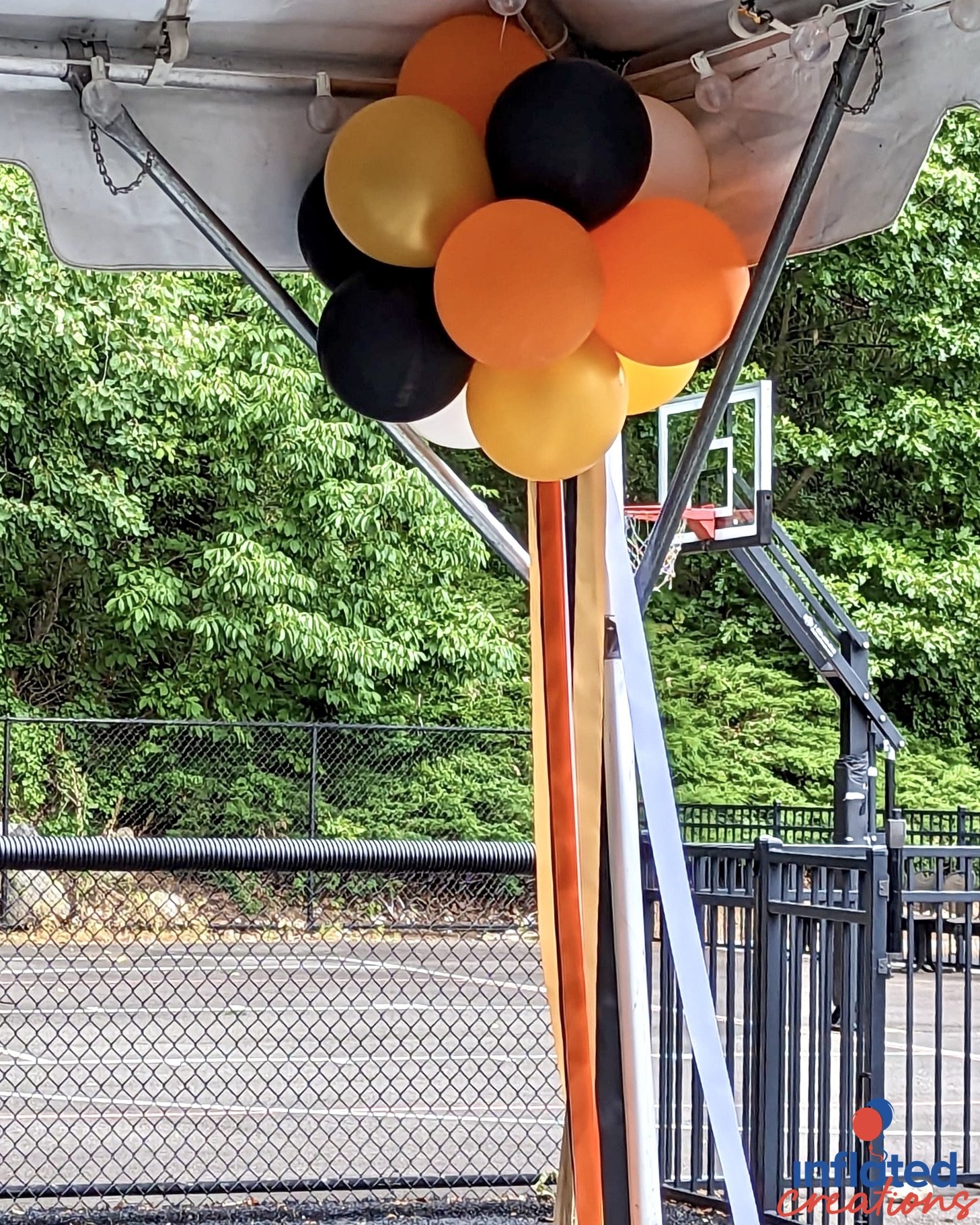 orange, gold yellow chrome, white, black balloon topiary puffball tent decor with long ribbons