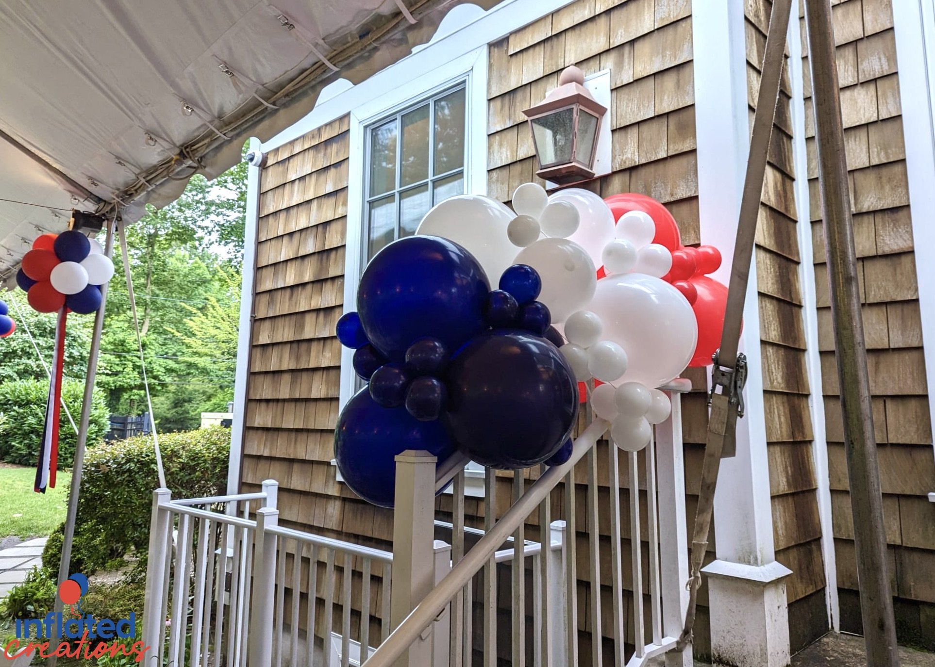 usa america red white blue patriotic outdoor tent party balloons topiary puffballs with long ribbons organic balloon accent on staircase bannister