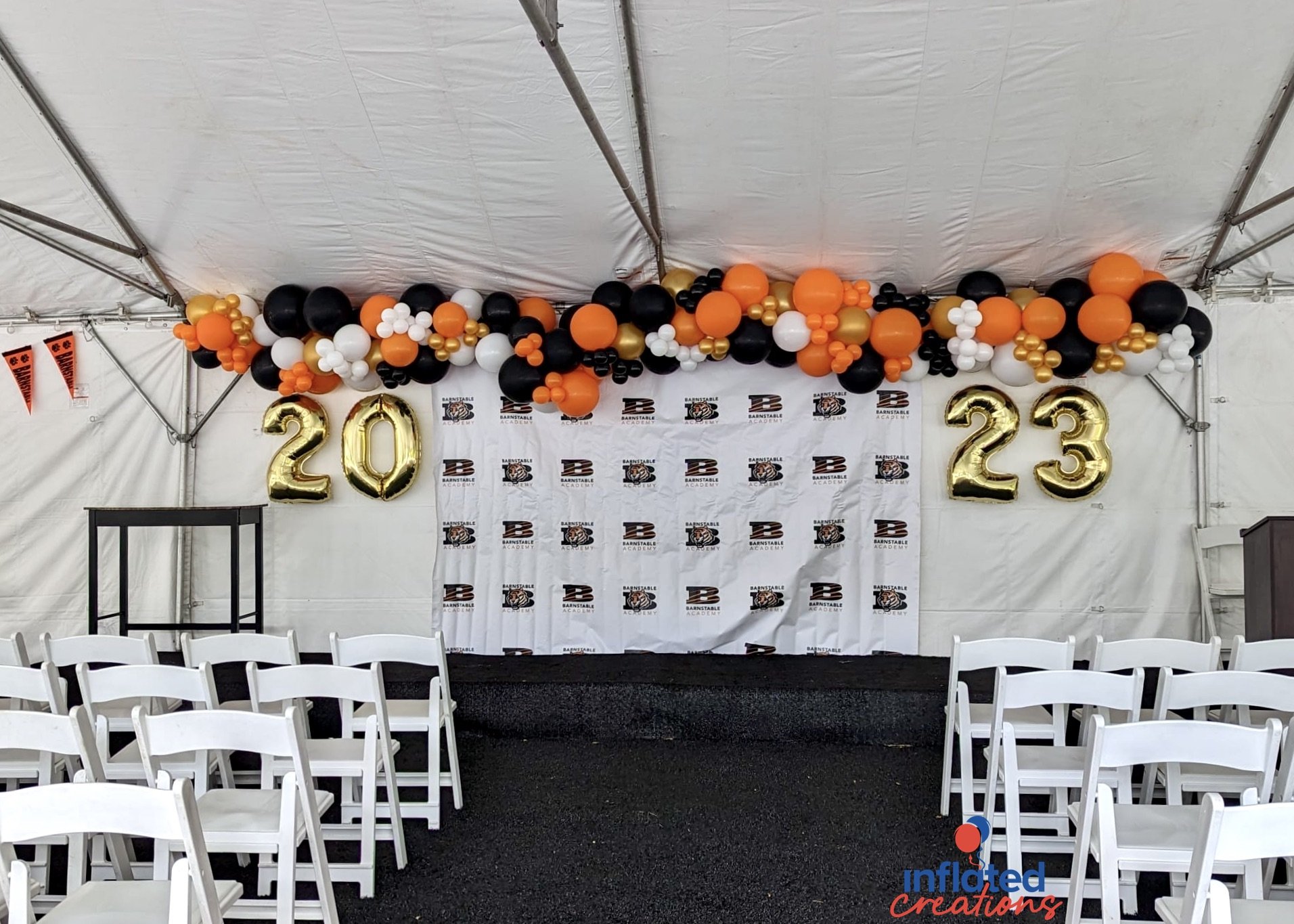 graduation year letters megaloons orange, gold yellow chrome, white, black organic balloon garland backdrop step and repeat