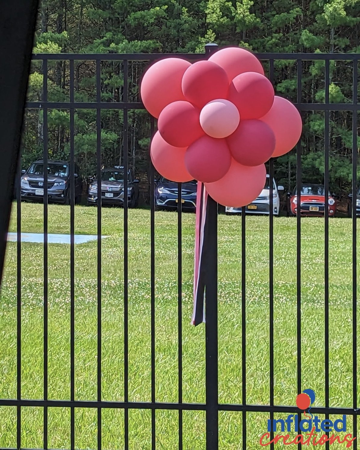 outdoor balloon decor balloon topiaries, puffballs, hot pink, pink, flowers on fence