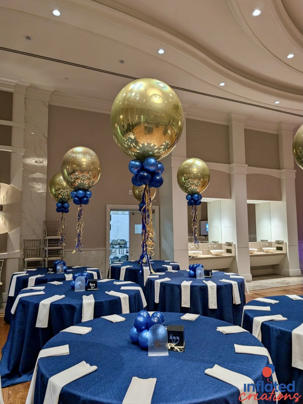 gold chrome and blue balloon centerpieces tables.jpeg