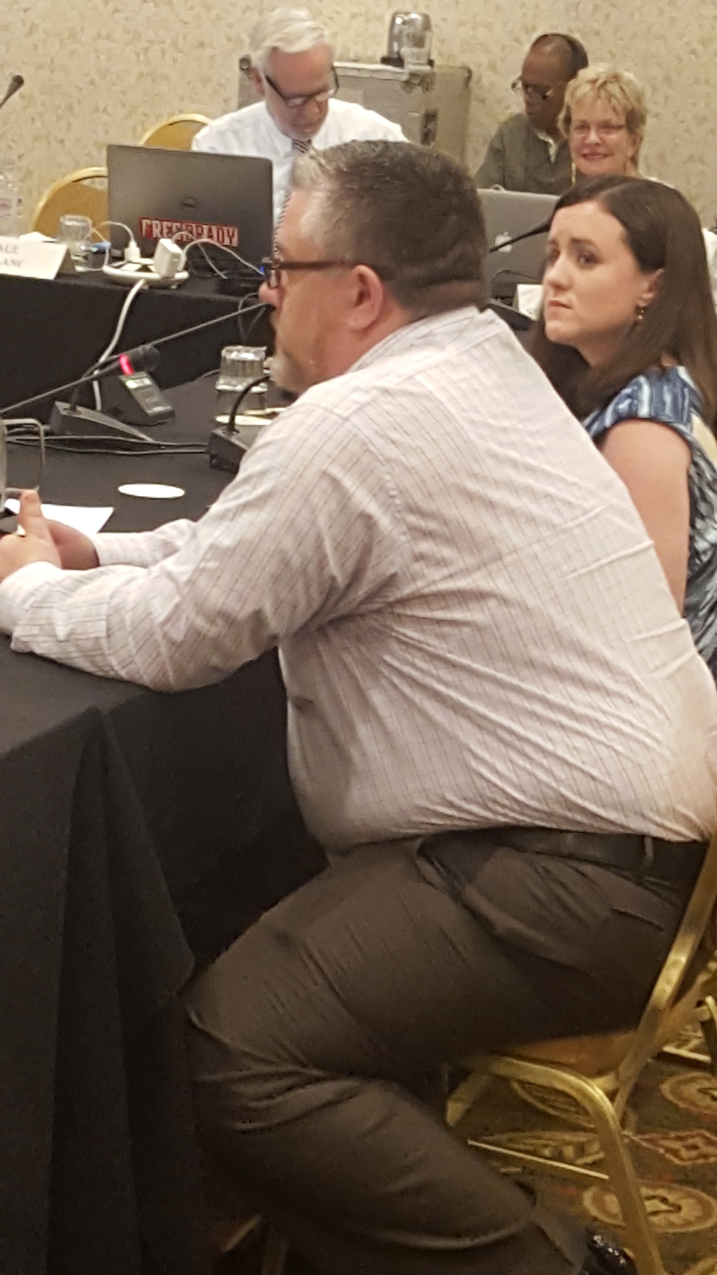 Matt Mitchell, a student veteran, and Sara nolan collins, legal services director, testify at naciqi meeting concerning acics accreditation