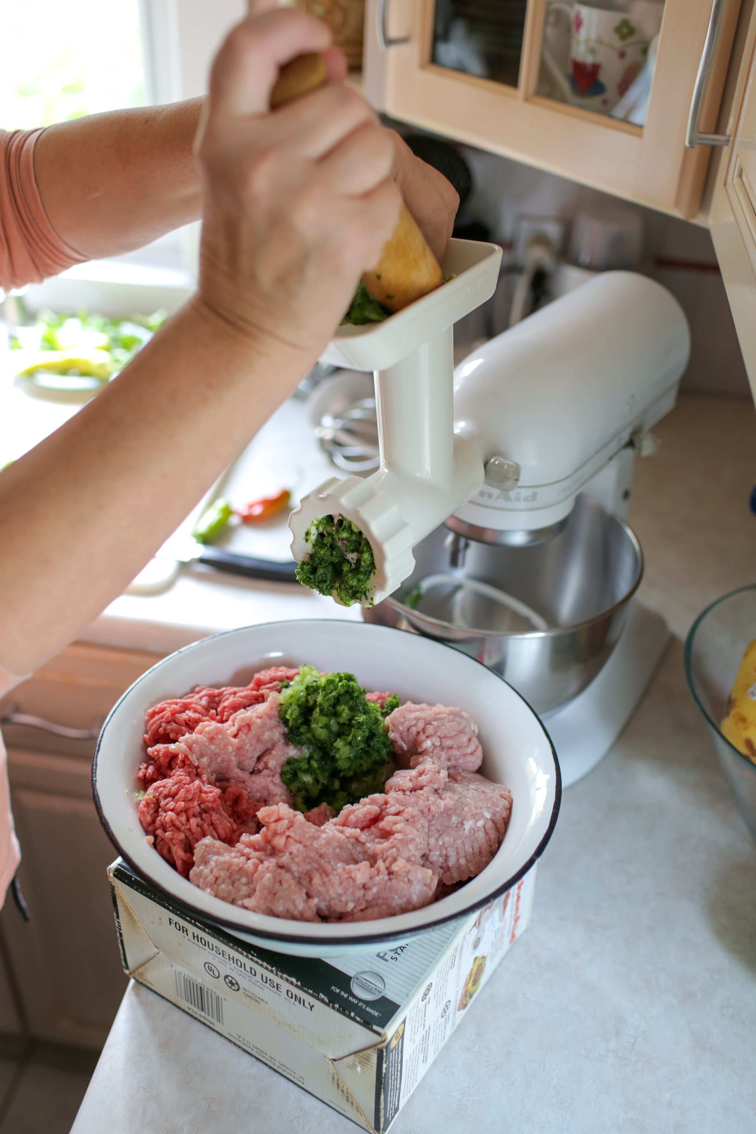  6. For filling, finely chop or grind herbs and onions and add to a large bowl with the meat.&nbsp; 