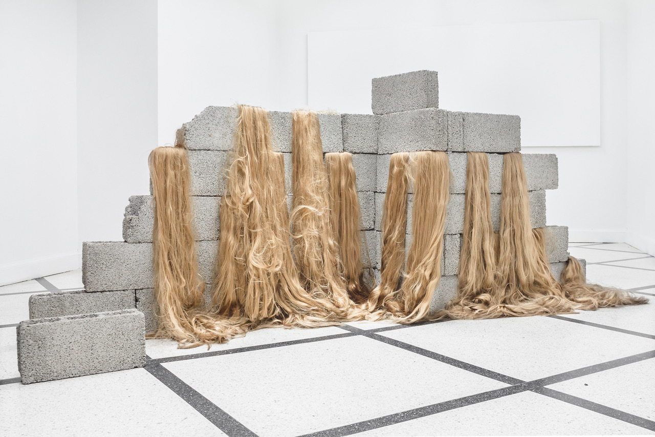 Sad wall, 2018,  concrete blocks, synthetic hair,  dimensions variable 