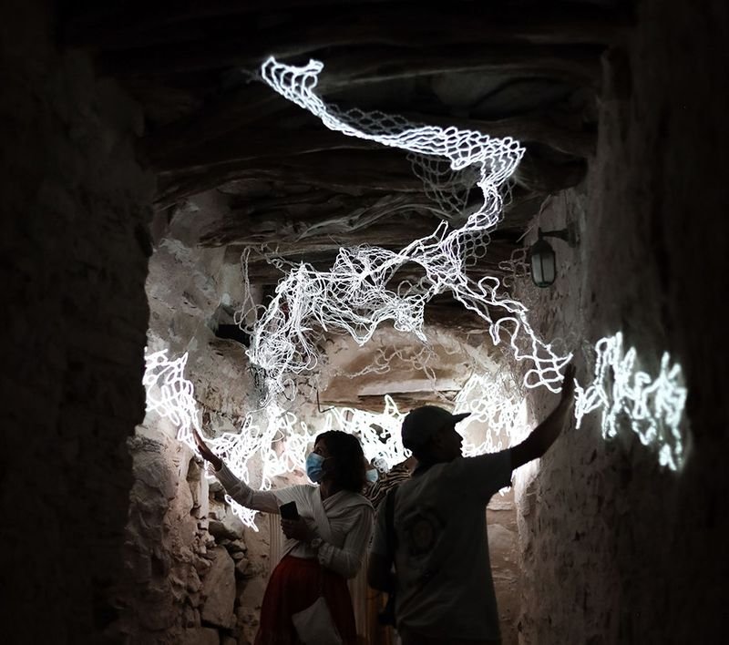   Still, Missing You (Sikinos),  2021, Electroluminescent wire, silver coated thread, operating boards, human bodies, 108x60x264 inches    