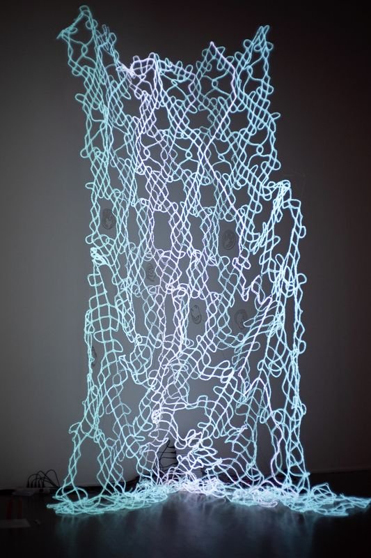   Still, Missing You (1559),  2021, Electroluminescent wire, silver coated thread, operating boards, human bodies, 144x120x36 inches    