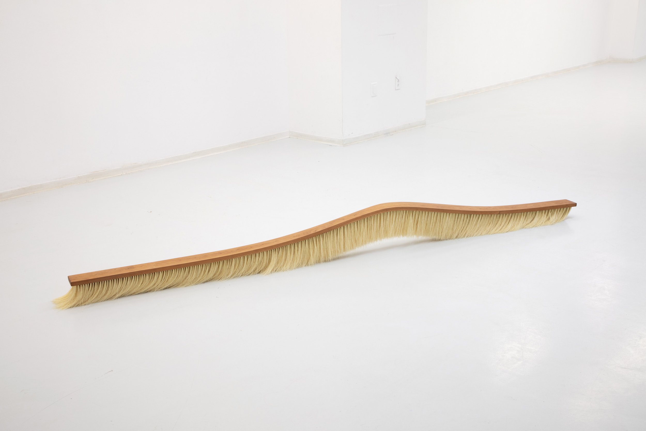   Sweep,  2022, Cherry wood, natural fibers, 6” W x 10’ L x 8” H, Photo Credits: Alberto Porro 
