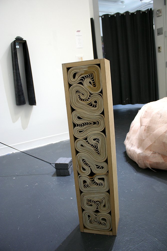   Untitled (coffin),  2022, MDF, rubber bands, 36 x 8 x 5 in 