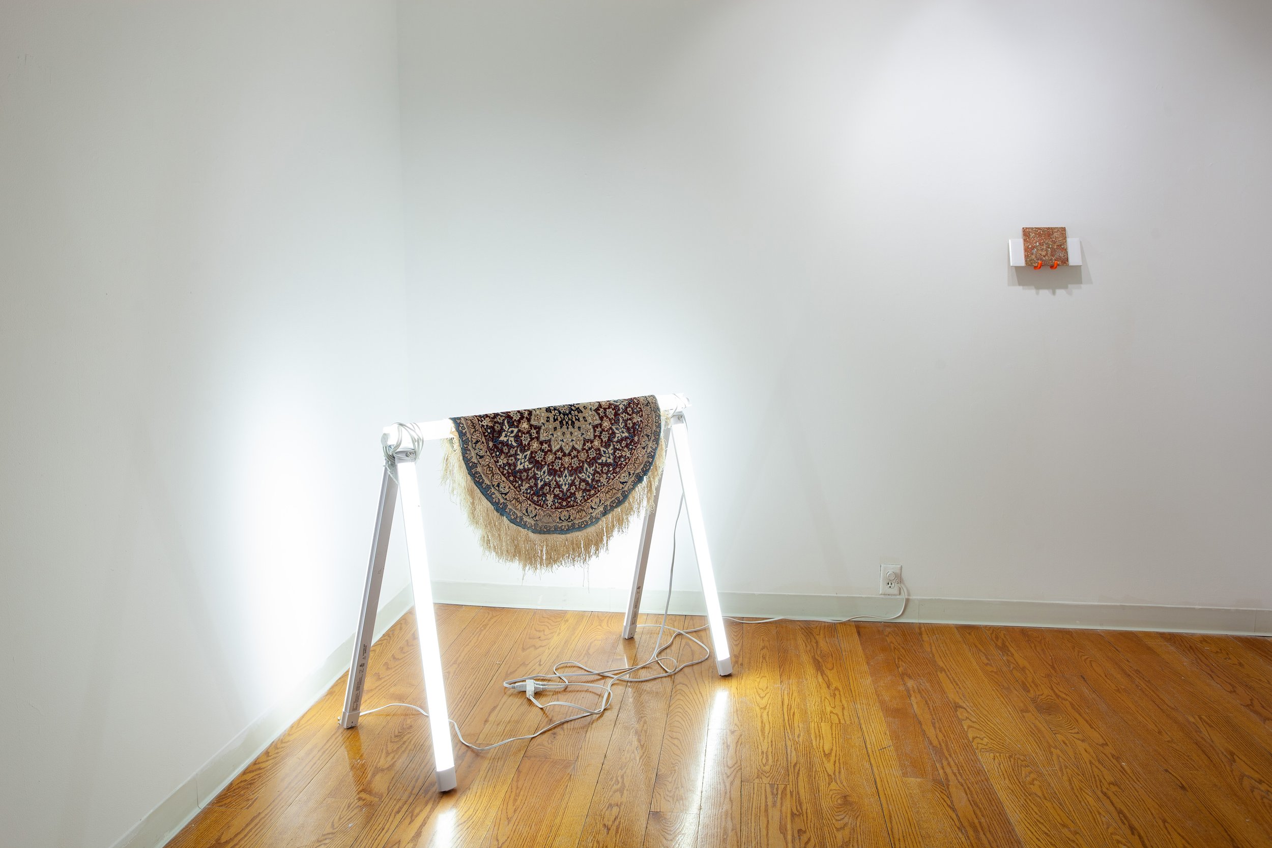   Sawhorse (for working),  2022, LED lights, Persian silk carpet, ceramic, 24 x 52 x 30 inches 