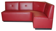 Tallemara Designer Banquette As Displayed: Red Vinyl Dimensions: L: 72″ x 72″ D: 26″ H: 36″ Available in custom sizes & fabrics. This custom design with the accent button in the perfect place, contrast welting provides some additional detail.
