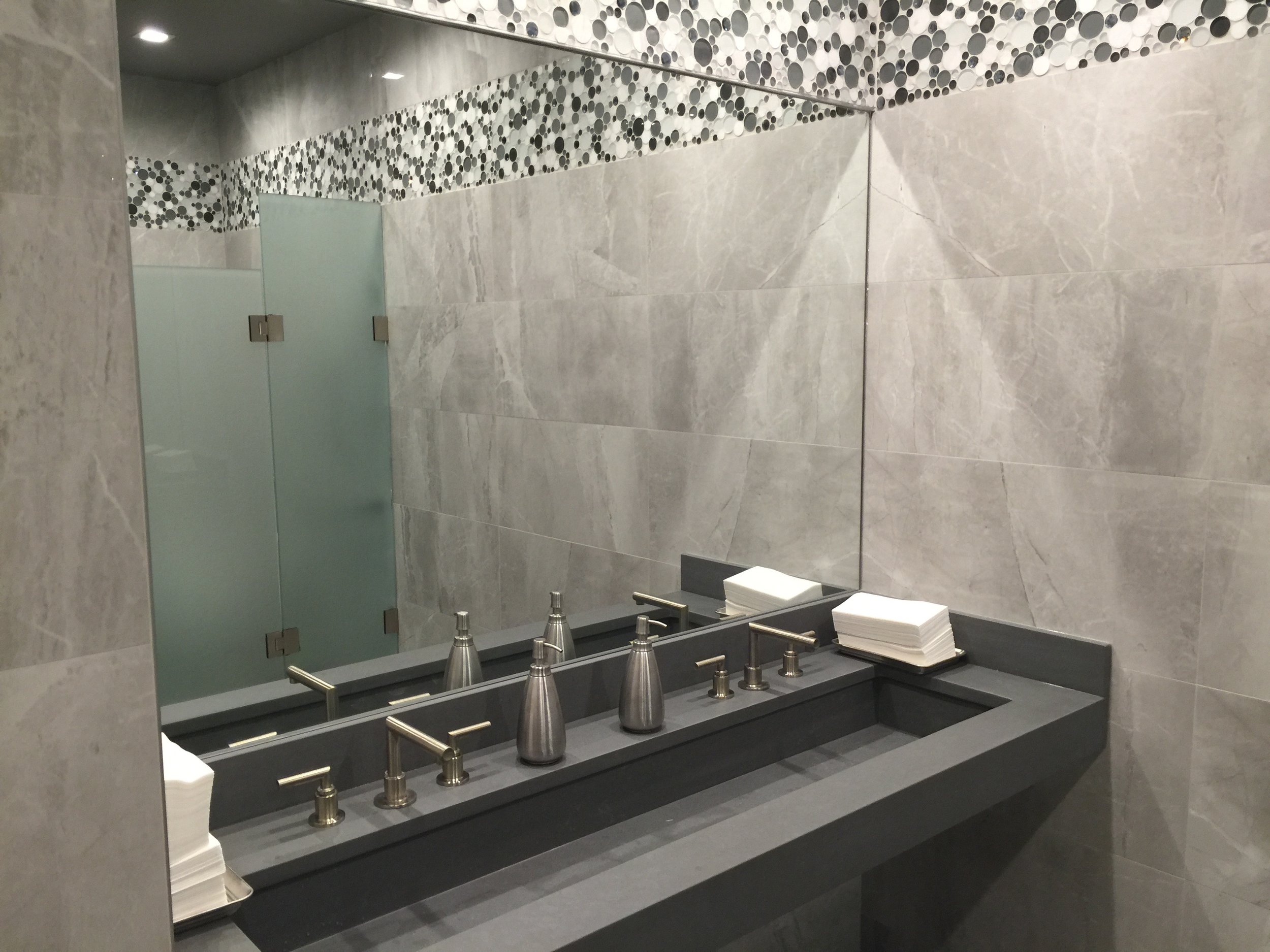 Men's Room with Custom Poured Concrete Trough Sinks