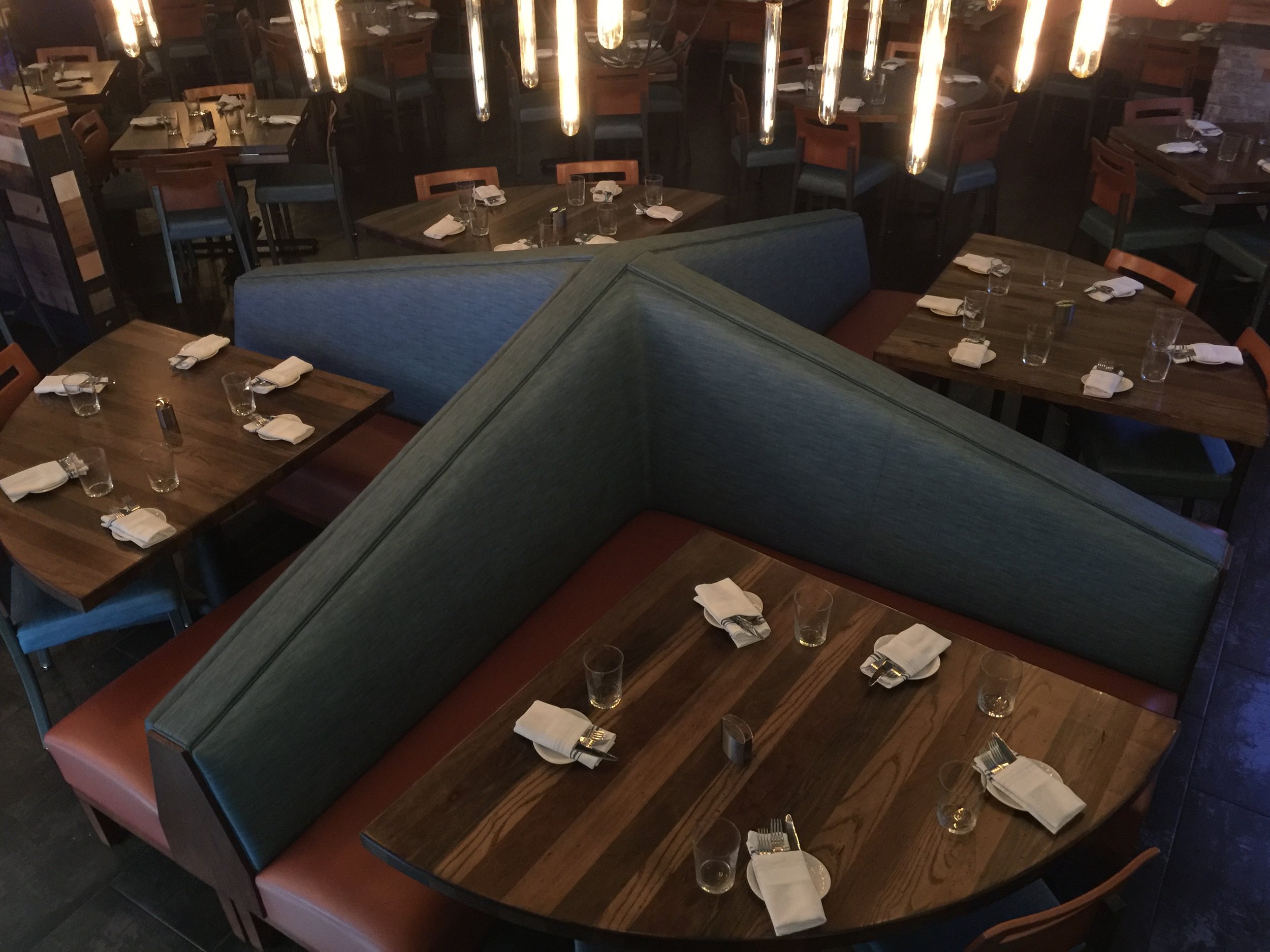Raymond Haldeman's Pinwheel Banquette Design ®™ highlighting random species farm-house distressed radiated 3 sided table with Vintage Stain.
