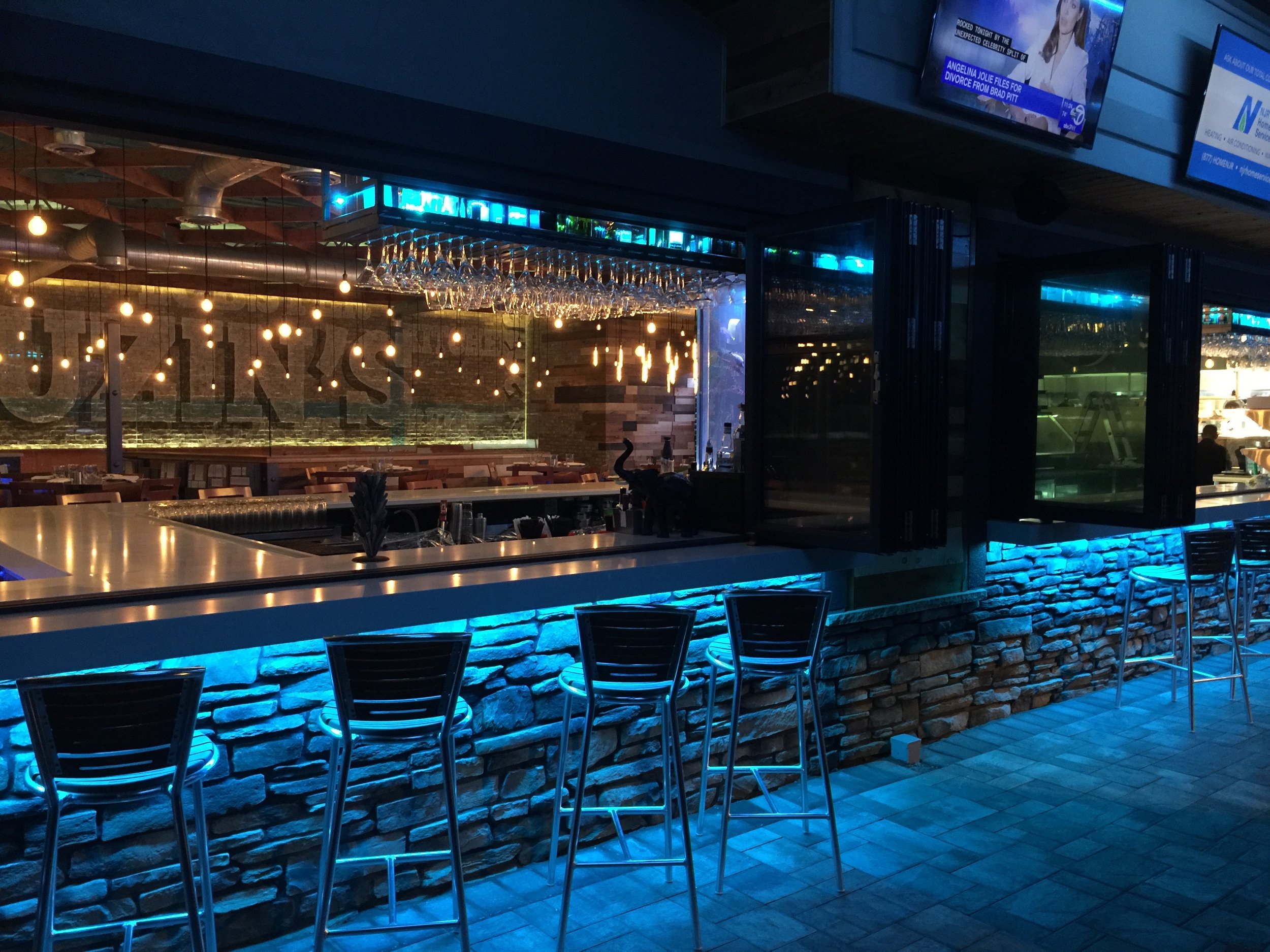Outdoor Pergola Covered Patio and Indoor Bar become ONE when Accordion Windows are opened.
