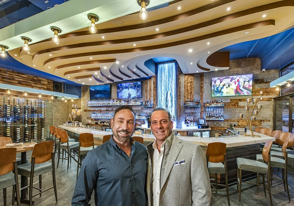 Charles Mayo with Restaurant Designer Raymond Haldeman in front of the digital waterfall he designed