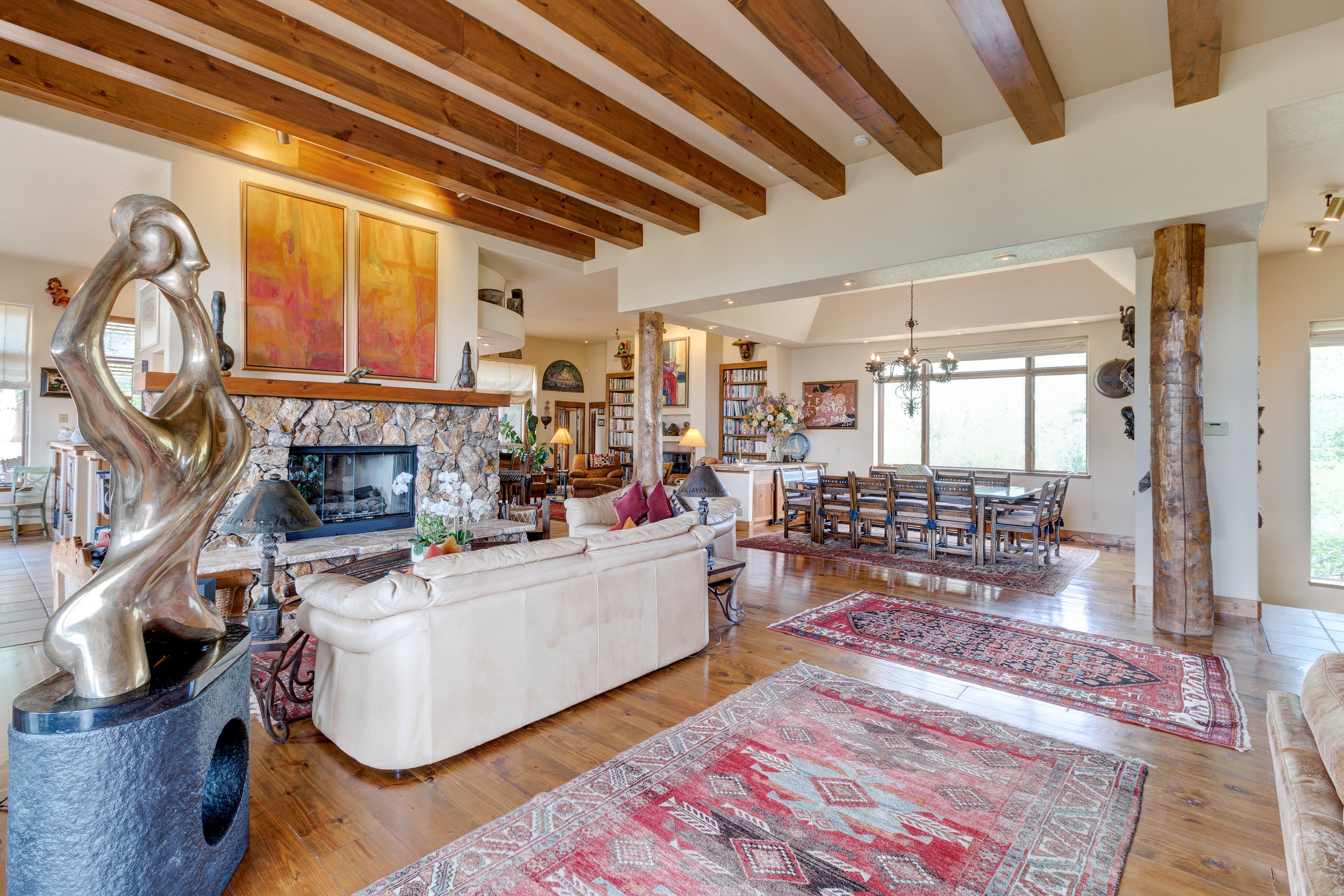 10-Great room opens to dining room with pine beams at the entrance.jpg