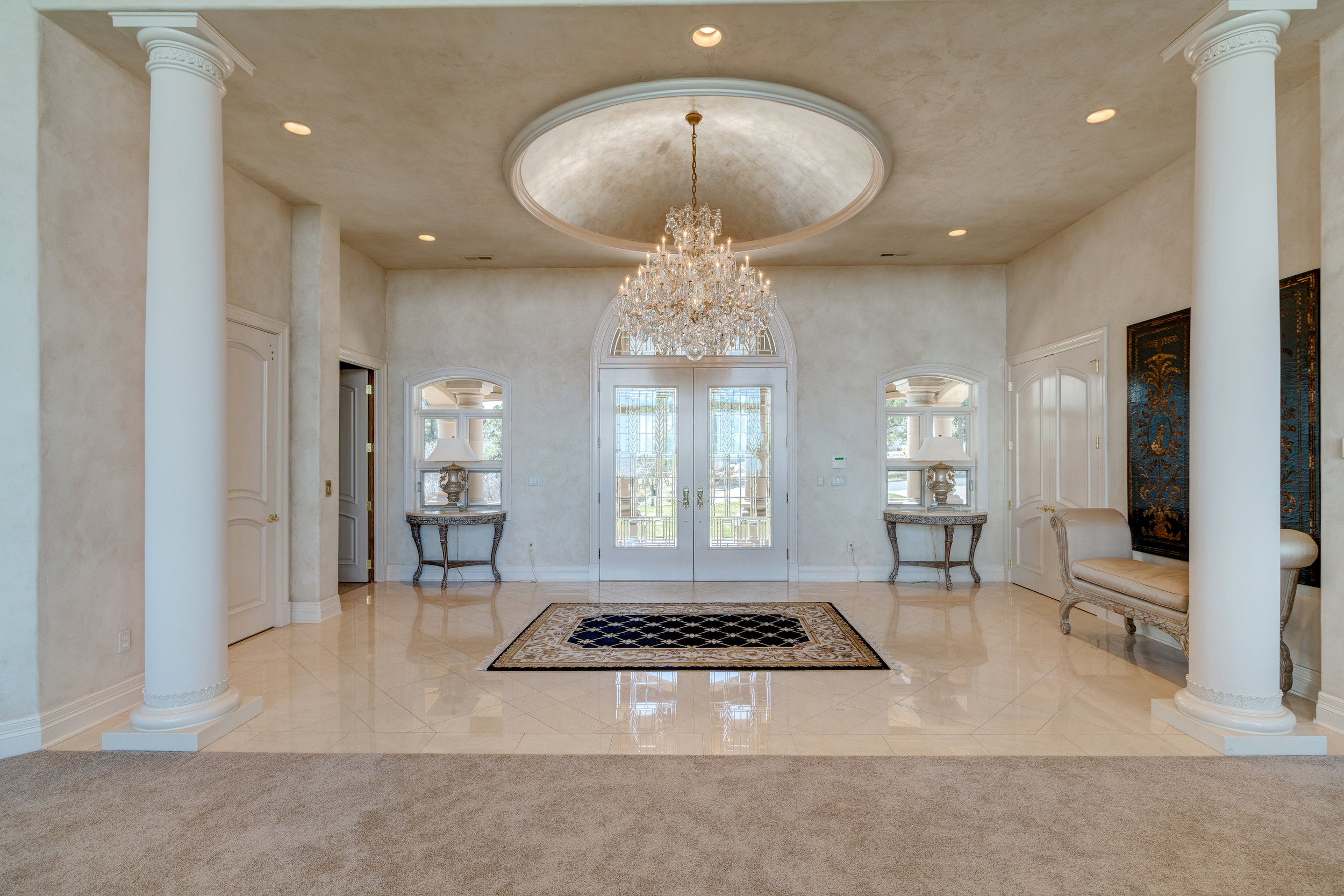 2-Impressive grand entry with crystal chandelier and marble floors opens to great room.jpg