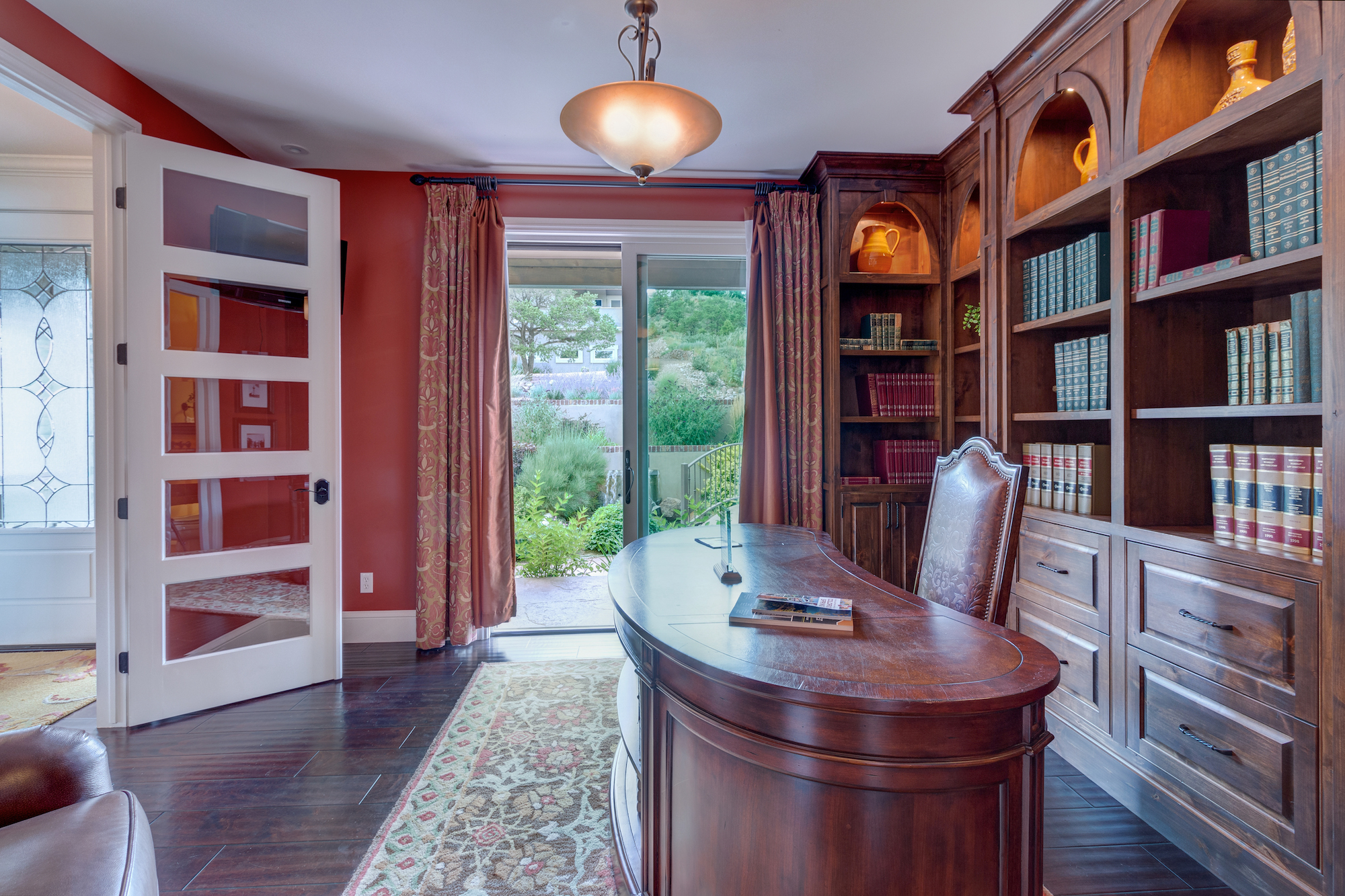 017-Office with bookcases and slider that opens to stream and water feature.jpg