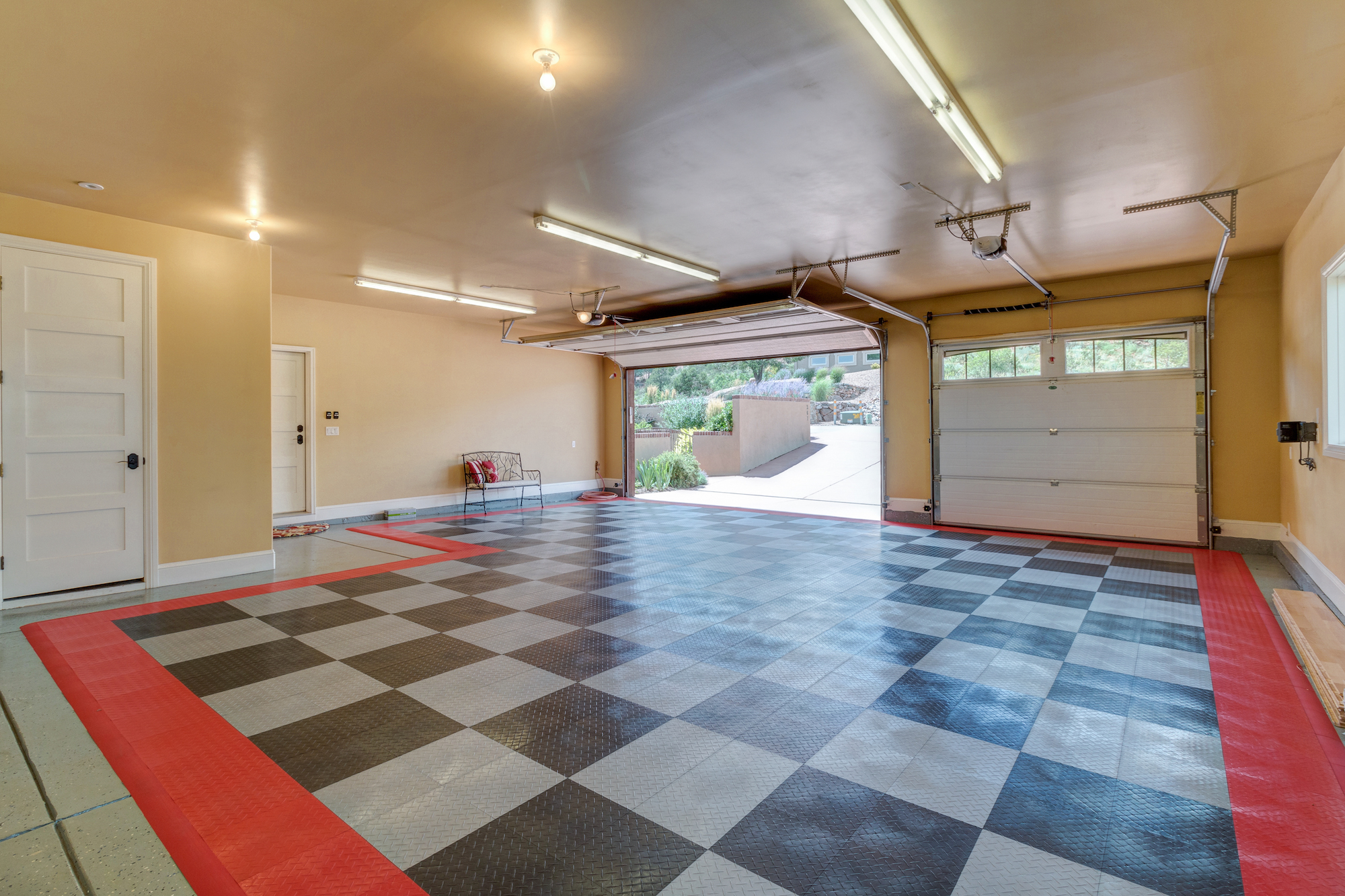 035-Finished garage with race car floor mat and storage area.jpg