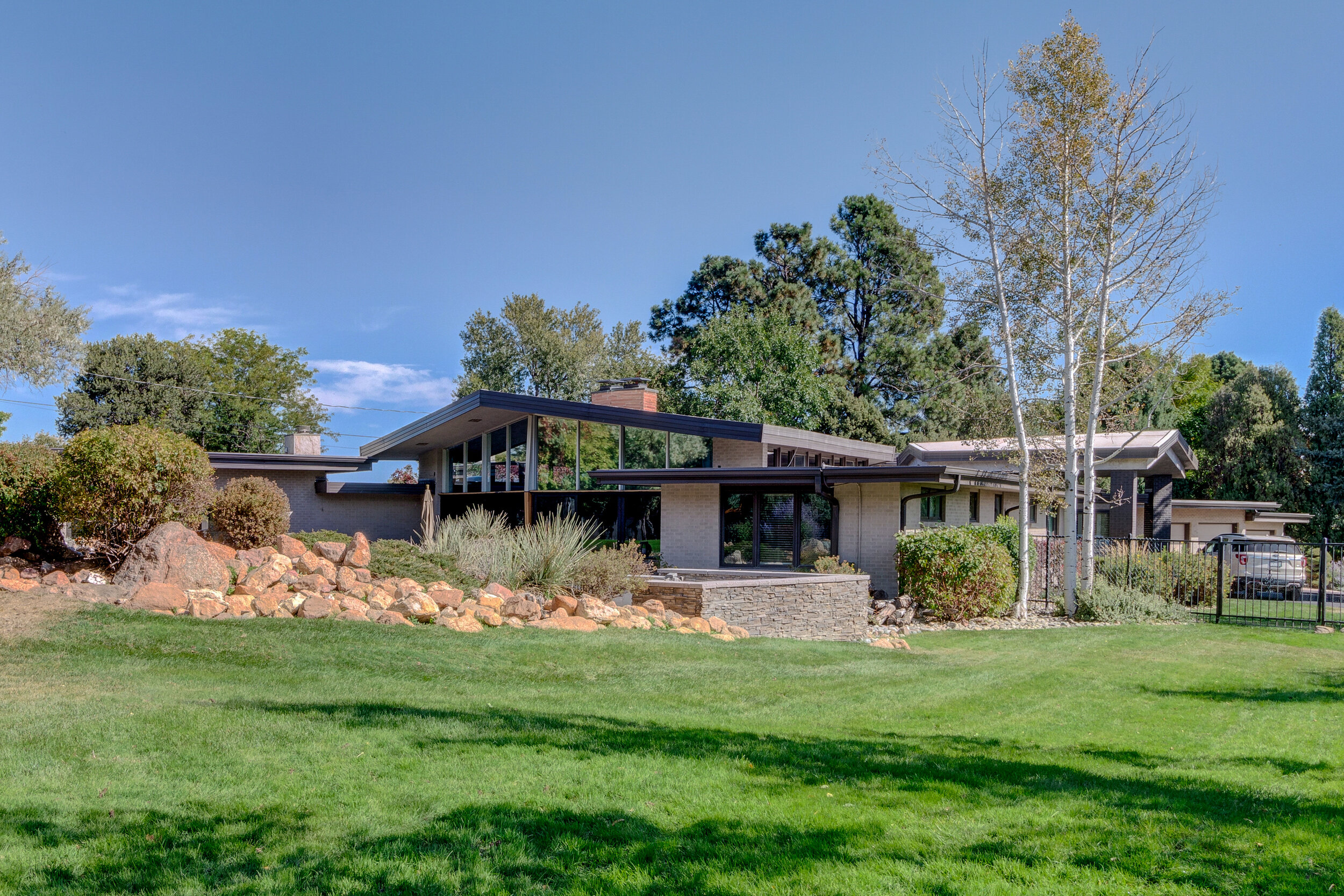 Front of house that faces Lake Ave + side of home that opens to lush acre lot