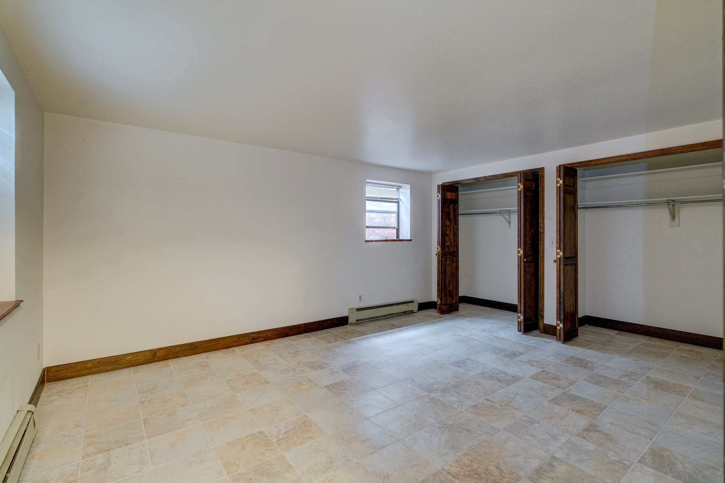 26-One of 2 guest bedrooms in basement. Both with tile floors.jpg
