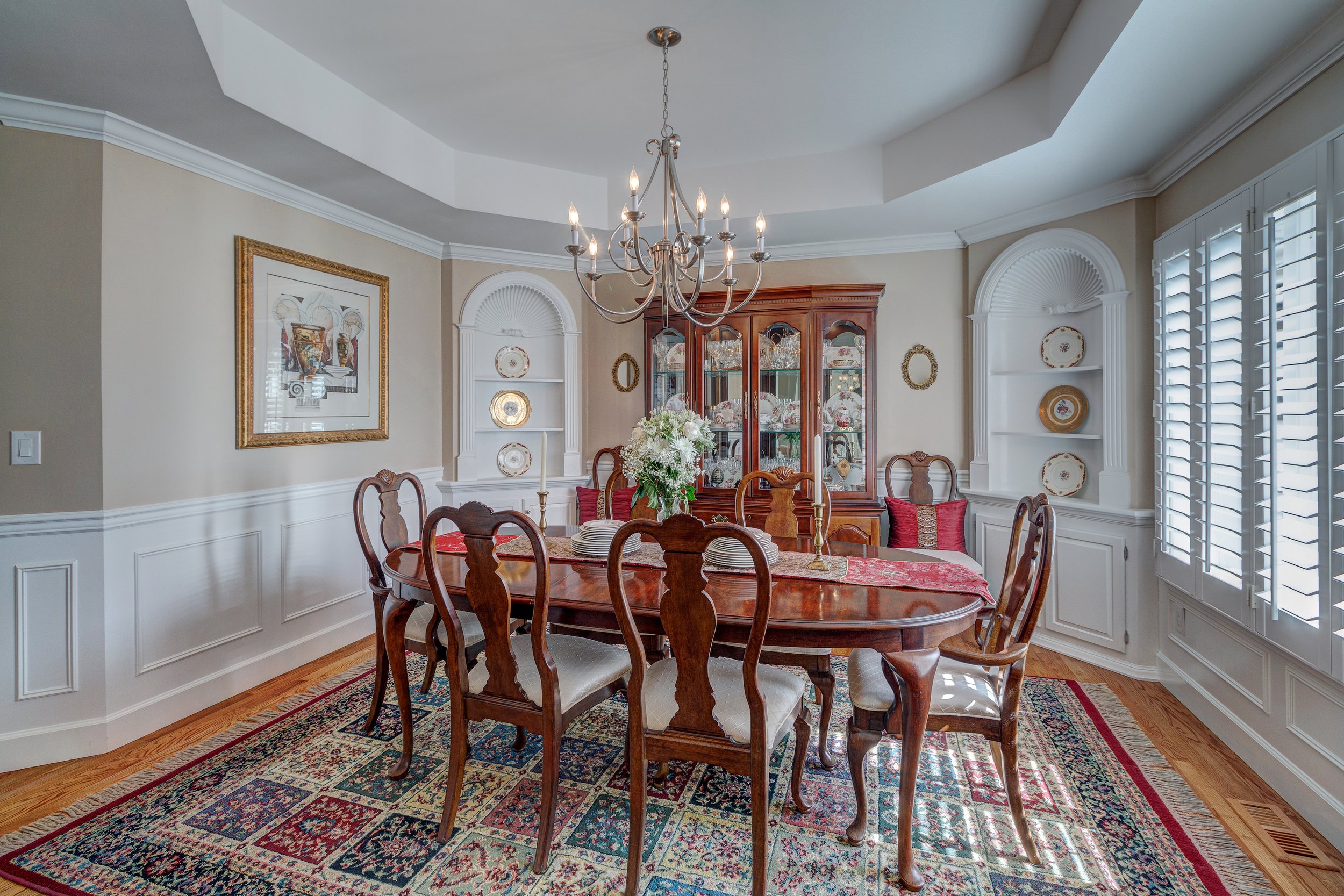 11-Formal dining room w wainscoting coved ceiling + corner built-ins.jpg