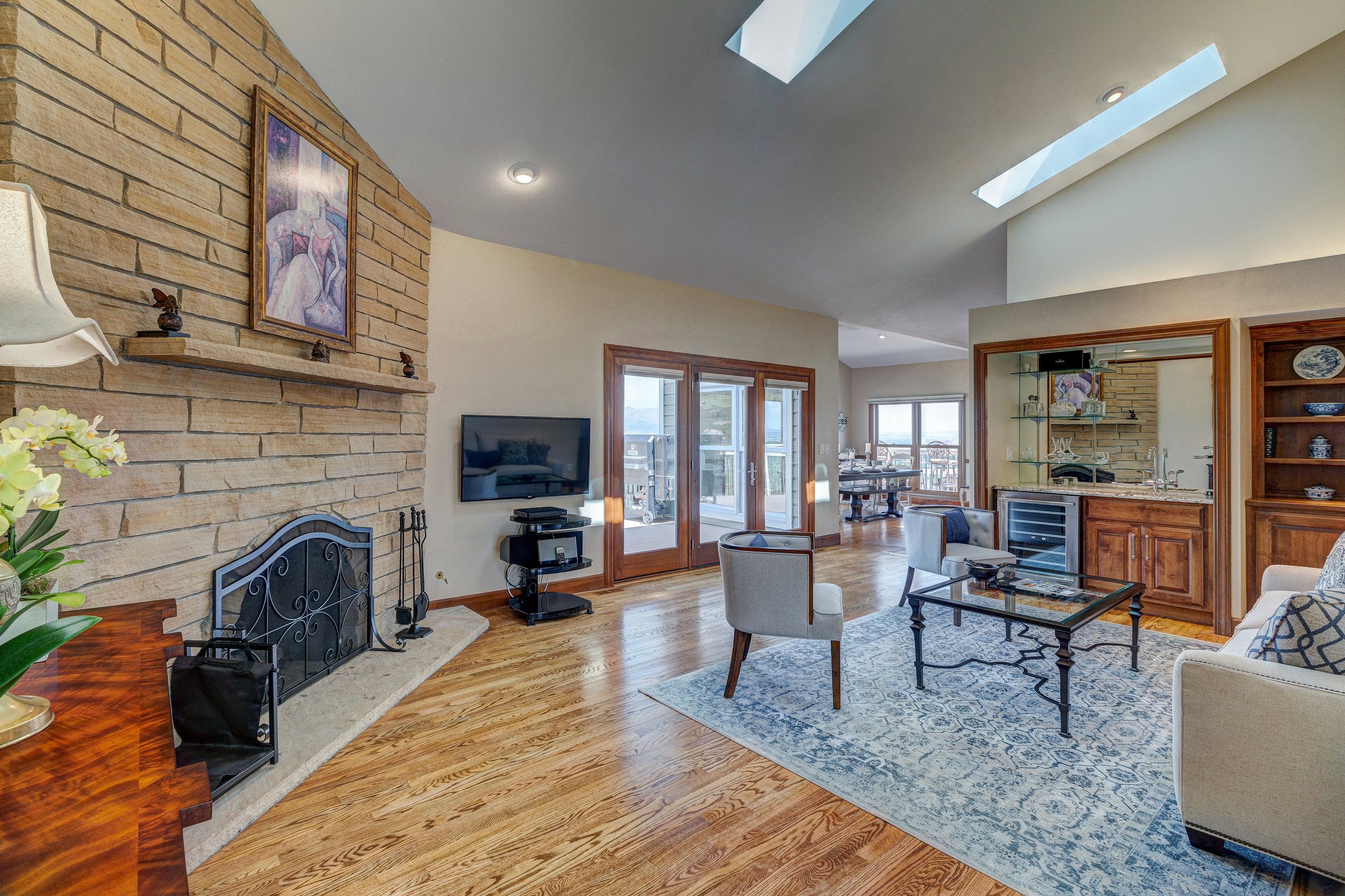 18-FR off kitchen w stone fp wet bar vaulted ceiling + deck access.jpg