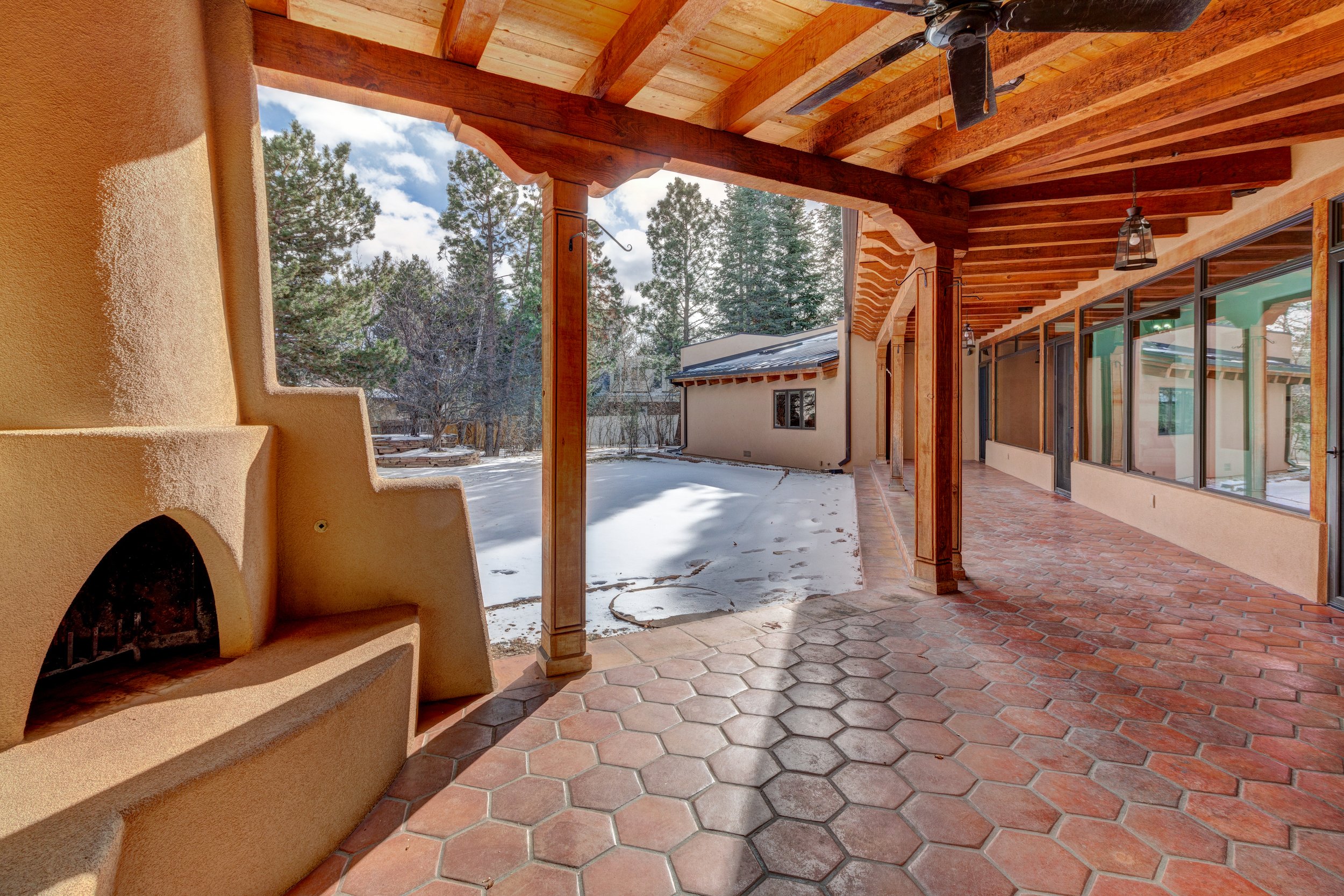 002-Expansive back patio w beamed wood ceiling saltillo tiled floor + kiva.jpg