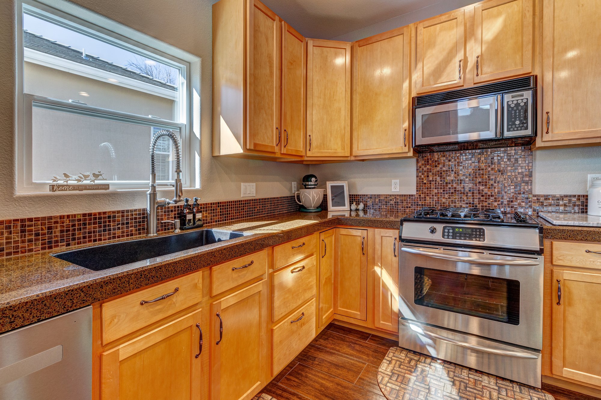7-Kitchen has stainless appliances to include a stove w gas cooktop.jpg