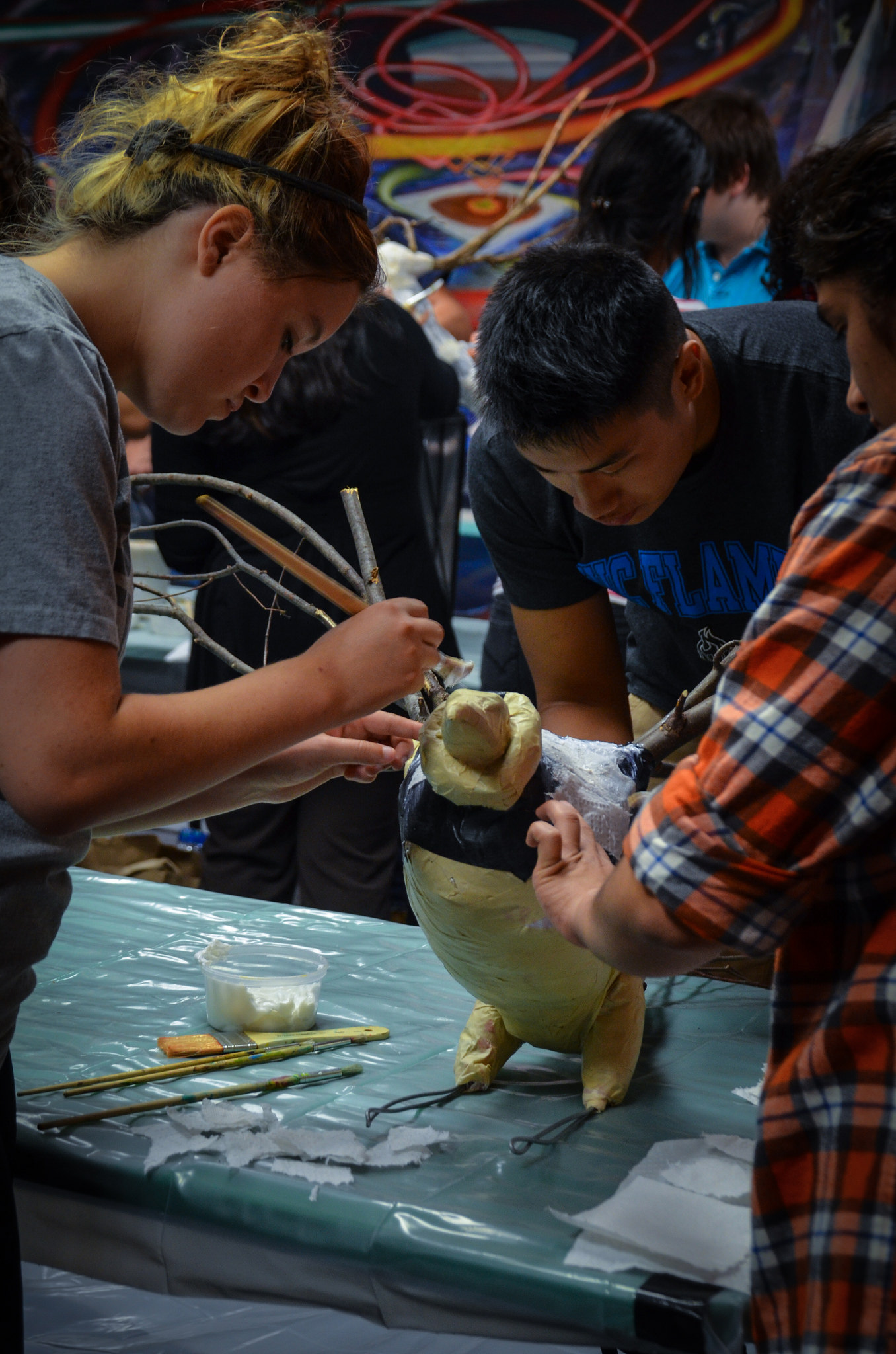 People working on bird sculpture