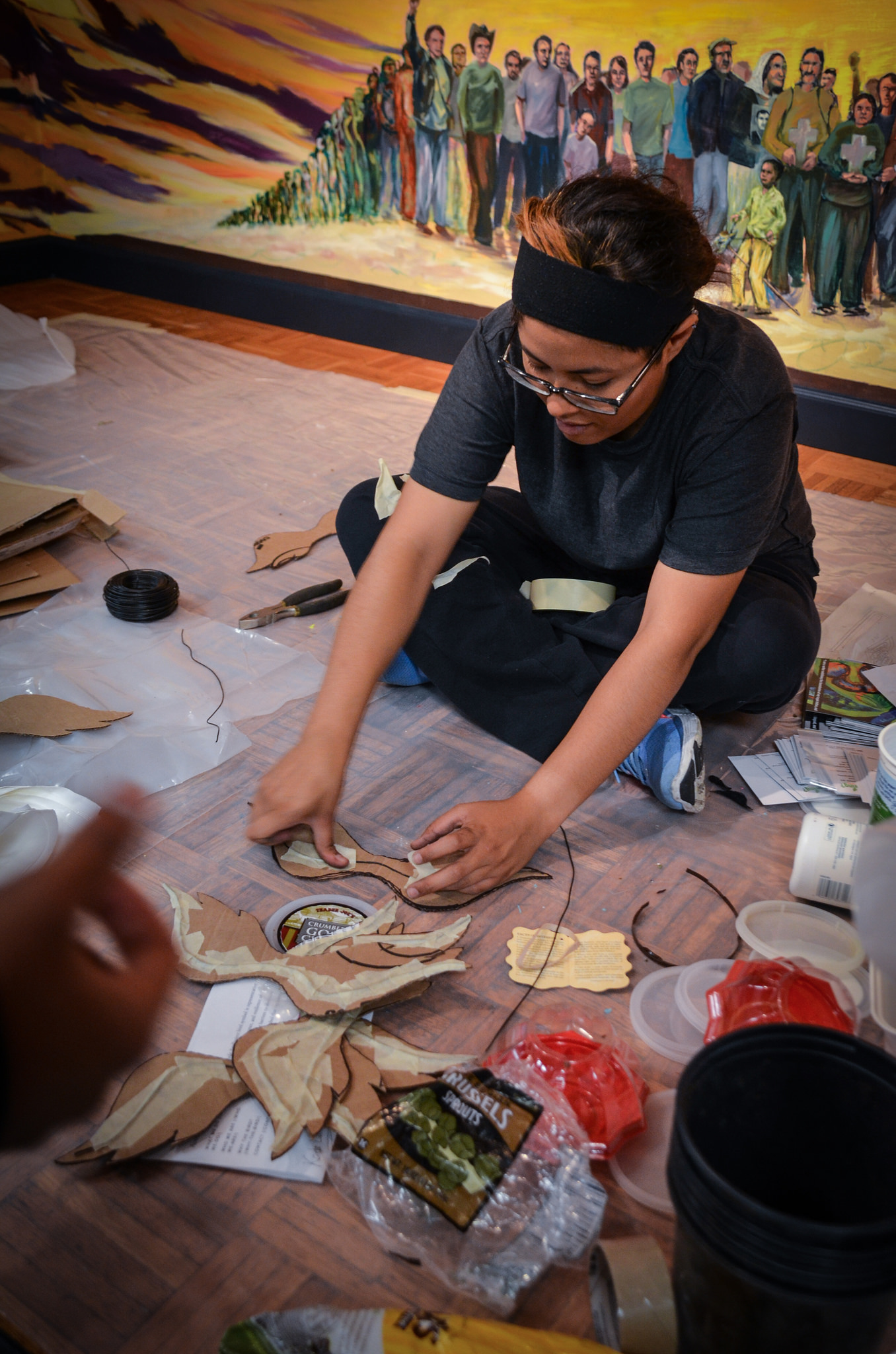 People working on bird sculpture