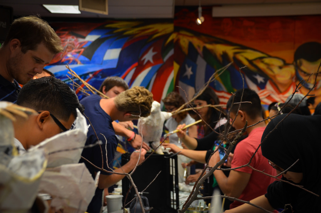 People working on bird sculpture