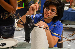 People working on bird sculpture